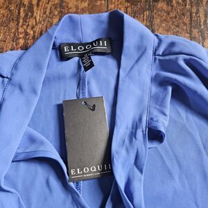 Eloquii blue tie-neck short-sleeve blouse V-neckline and relaxed flared sleeves.